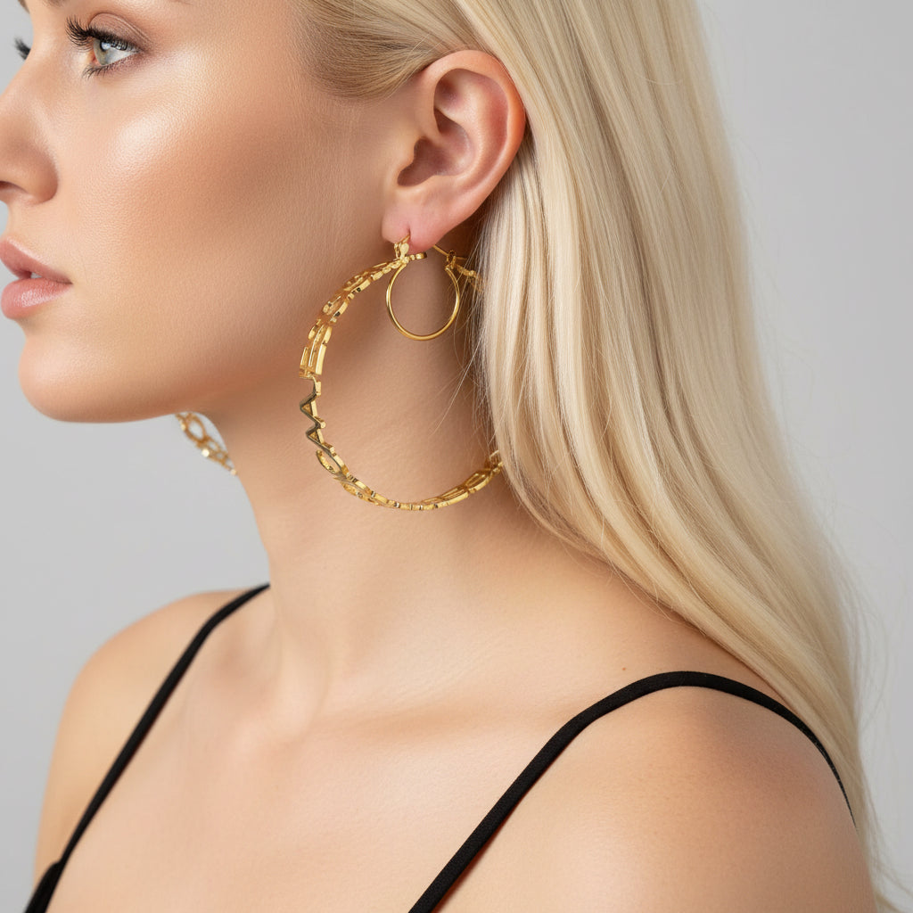 Gold hoop earrings worn by a person with dark hair.