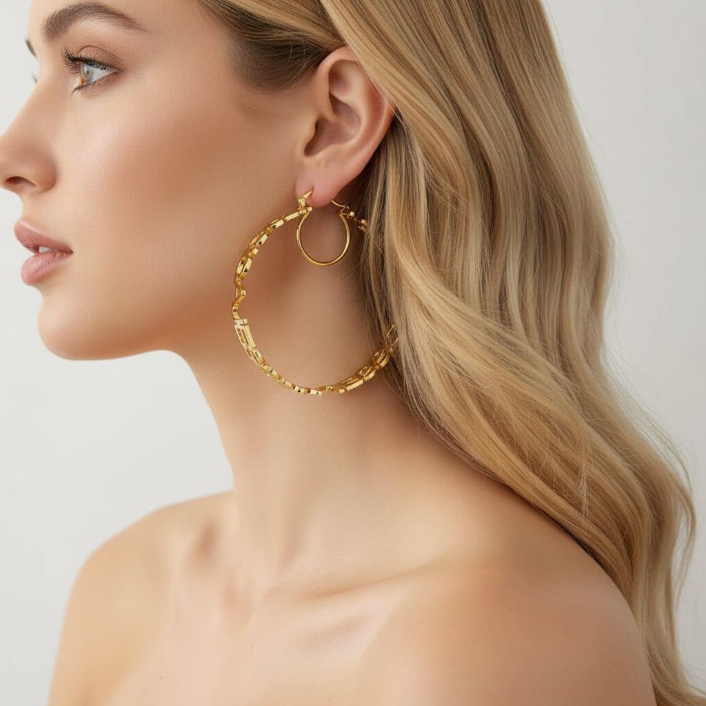 Gold hoop earring worn by a person with a neutral background